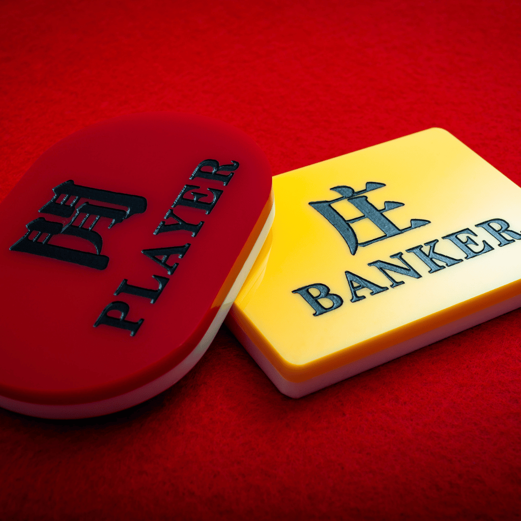 Banker and player chips on red table felt